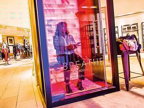 It's all experiences now - a shopper gets a feel of Breathe salt rooms at The Wellery on the second floor of the Saks Fifth Avenue flagship store in New York.