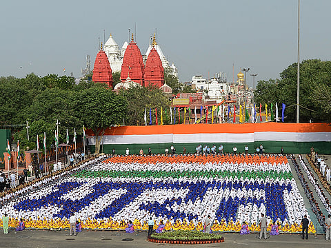 Indian schoolchildren sit in formation forming Hindi script that reads 'Bharat' (India) during the country's 71st Independence Day celebrations, which marks the 70th anniversary of the end of British colonial rule, at the historic Red Fort in New Delhi on August 15, 2017.  A controversy erupted recently, with the ruling Bharatiya Janata Party claiming that Bharat was the indigenous, therefore preferred, name.