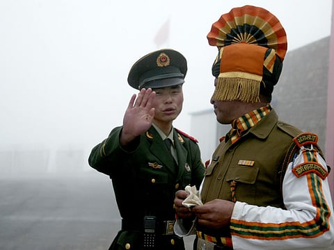 A Chinese soldier next to an Indian soldier at the Nathu La border crossing between India and China in India's northeastern Sikkim state (file)