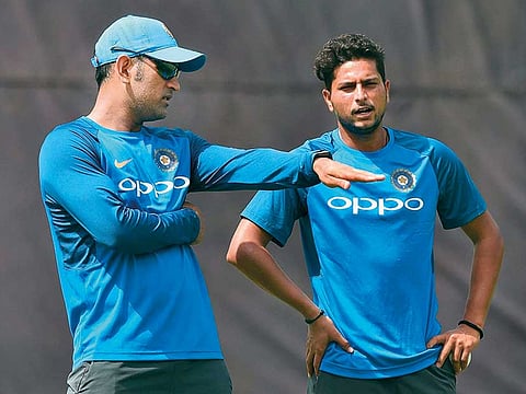 Mahendra Singh Dhoni (left) had always been a great source of cricketing intelligence and inputs for spinners like Kuldeep Yadav, according to Kiran More.