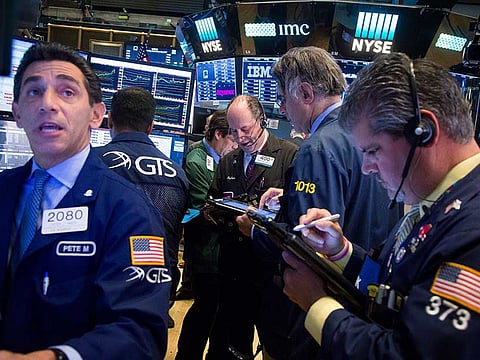 Traders work on the floor of the New York Stock Exchange (NYSE) in New York, yesterday. US stocks tanked and bonds gained under pressure from the North Korean challenge.