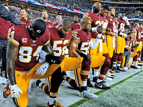 Washington Redskins players take a knee