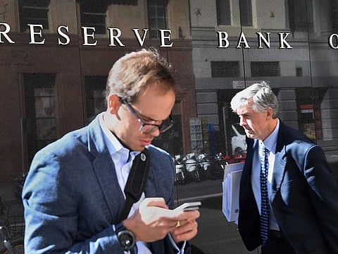 Men walk past the Reserve Bank of Australia in Sydney. Australia fell into its first recession in almost 30 years with the economy contracting in the three months through June, while the recovery is buffeted by Victoria state’s renewed Covid outbreak and lockdown.