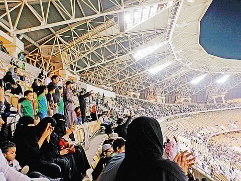 Saudi women watch a football match at the King Abdullah Sports City in Jeddah, Saudi Arabia.