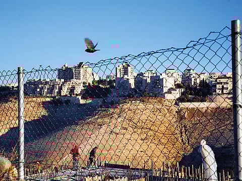 File picture: Palestinian laborers work at a construction site in a new housing project in the Israeli colony of Maale Adumim, near occupied Jerusalem.