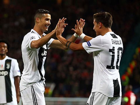 Paulo Dybala, right, celebrates with Cristiano Ronaldo.