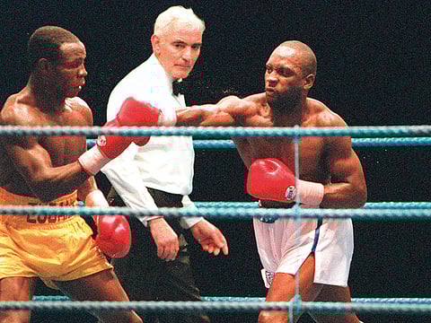 British boxer Nigel Benn throws a punch at Chris Eubank in 1990