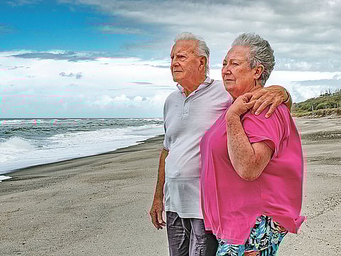 In this Oct. 29, 2018 photo fisherman Gus Hutt is with his wife Sue where he saved saved 18-month-old Malachi Reeve after he had escaped from his parents' tent at Matata Beach, near Whakatane, New Zealand.