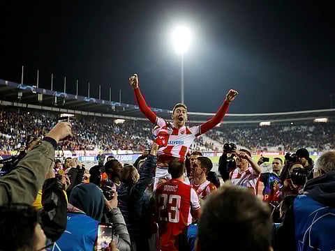 Red Star Belgrade's Milan Pavkov celebrates with teammates after the match.