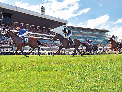 Jockey Kerrin McEvoy on British horse Cross Counter (left) heads to the finish line to win the Melbourne Cup.