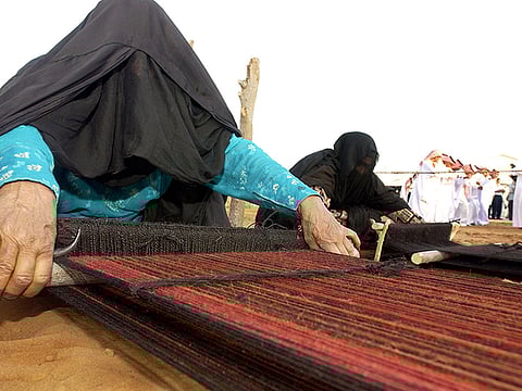 A Bedouin woman demonstrates traditional weaving techniques at the Al Shindagha heritage site in this 2003 file photo.