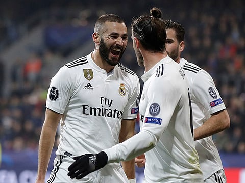 Real forward Karim Benzema, left, celebrates after scoring his side's third goal.