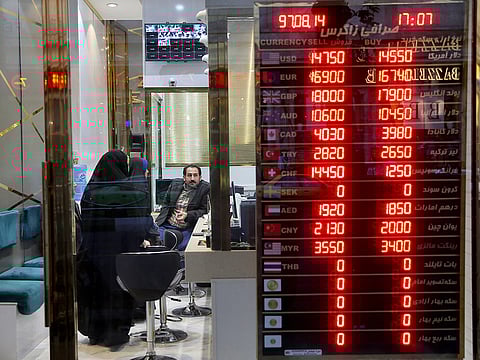 Customers speak with a money exchanger at his shop in downtown Tehran, Iran. Picture used for illustrative purposes.