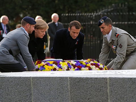 French President Emmanuel Macron, second right, and German Chancellor Angela Merkel lay a wreath of flowers during a ceremony in Compiegne, north of Paris, Saturday, Nov. 10, 2018. The leaders of France and Germany have held an intimate commemoration at the site north of Paris where the vanquished Germans and victorious but exhausted Allies put an end to the First World War. US' Trump did not attend the ceremony.