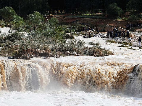 Civil defence members look for missing persons in flash floods in Madaba city, near Amman, Jordan.