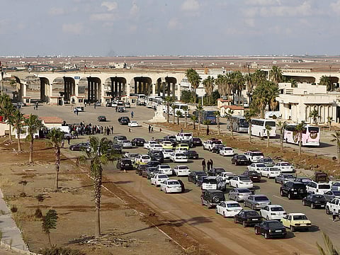 Vehicles wait to cross at the Nassib border crossing between Jordan and Syria.