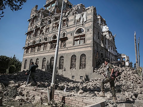 Houthi Shiite rebels inspect the rubble of the Republican Palace that was destroyed by Saudi-led airstrikes, in Sanaa, Yemen