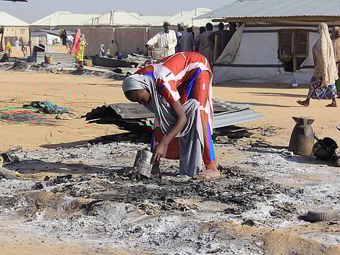 A resident tries to salvage valuables from burnt house following multiple attacks by Boko Haram Islamists at Dalori and other neighbouring villages outside the Borno state capital of Maiduguri, northeastern Nigeria, on November 1, 2018.