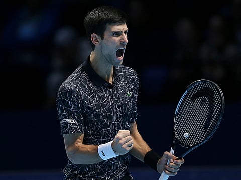 Novak Djokovic celebrates winning a point against John Isner.