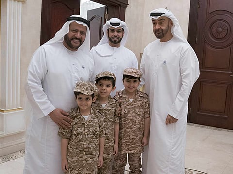 Shaikh Mohammad Bin Zayed Al Nahyan during a visit to the house of Major General (Ret) Khamis Matar Khalifa Al Mazrouei (L), in Khalifa City.