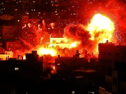 A ball of fire above the building housing the Hamas-run television station Al Aqsa TV in the Gaza Strip during an Israeli air strike.