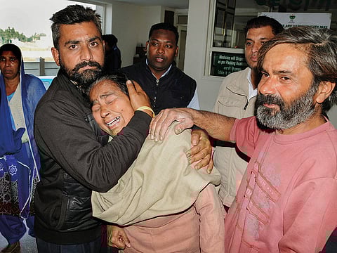 Relatives mourn a victim killed in the attack. About 200 devotees were inside the hall at the time of the incident.