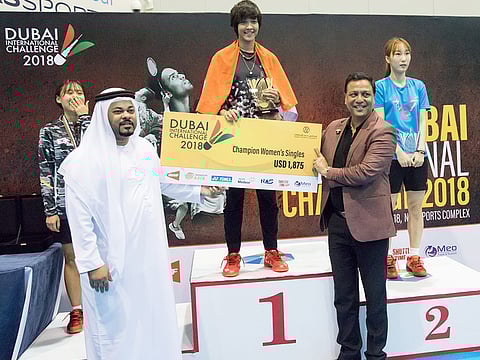 UAE Badminton Association Chairman Ghazi Al Madani, with Chair Post Nawab Shafi Ul Mulk, presents the trophy and prize money to Ashmita Chaliha after winning the Dubai International Challenge badminton tournament women’s singles title.