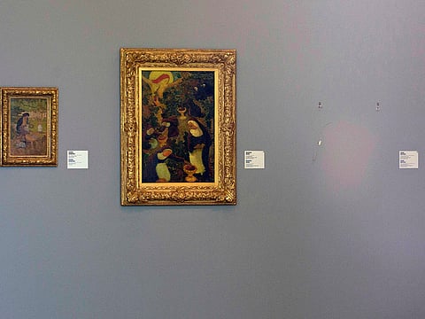 The empty space where Henri Matisse' painting "La Liseuse en Blanc et Jaune" was hanging, right, is seen next to a painting by Maurice Denis, center, and Pierre Bonnard, left, at Kunsthal museum in Rotterdam, Netherlands