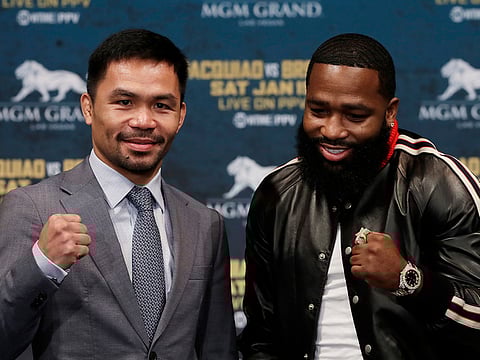 Manny Pacquiao, left, and Adrien Broner pose for photographers at a news conference, Monday, Nov. 19, 2018, in New York.