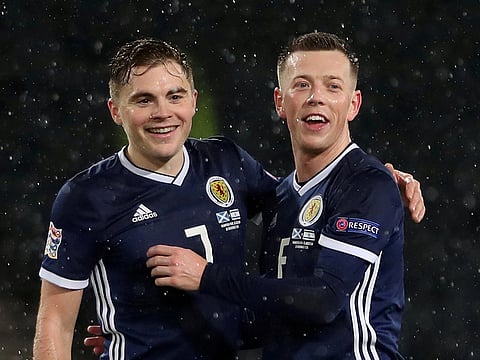 Scotland's James Forrest and Callum McGregor celebrate after the match.