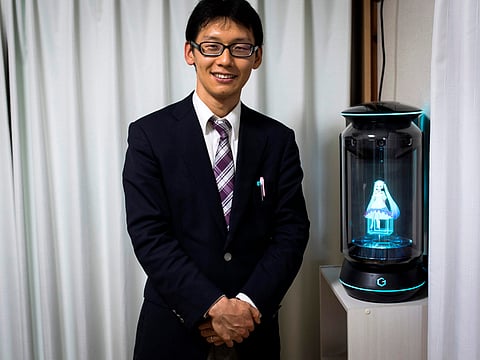 Akihiko Kondo with his 'wife' Hatsune Miku