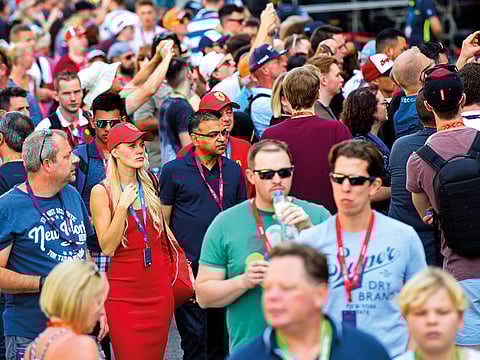 Formula 1 fans walk the pit lane ahead of Etihad Airways Abu Dhabi Grand Prix at Yas Marina circuit on Thursday.