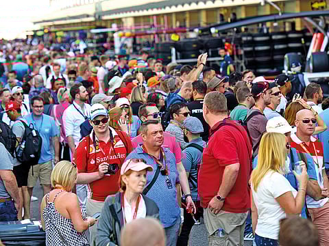Formula 1 fans walk the pit lane ahead of Etihad Airways Abu Dhabi Grand Prix at Yas Marina circuit on Thursday.