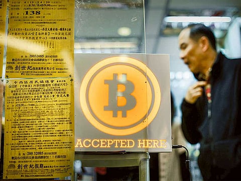 A shop displaying a Bitcoin sign in Hong Kong.