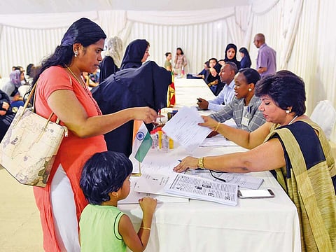 An amnesty seeker with an official from Indian Consulate, at the Al Aweer Federal Authority for Identity and Citizenship, General Directorate of Residency and Foreigners affairs, Dubai.