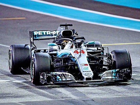 Lewis Hamilton of Mercedes celebrates after securing the pole