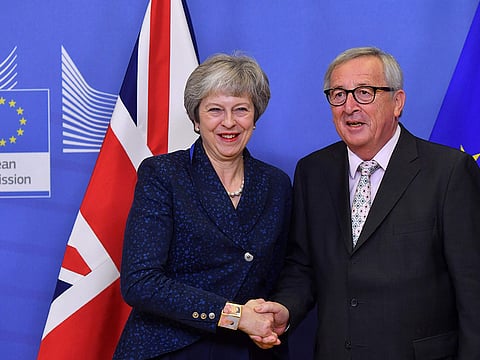 EU Commission President Jean-Claude Juncker shakes hands with Britain's Prime Minister Theresa May as she arrives for Brexit talks at the EU Headquarters in Brussels on November 24, 2018. British Prime Minister May met with EU Commission President Juncker in Brussels on November 24, for final talks ahead of a crucial Brexit summit. The pair did not make any public statements before they went into their meeting, which comes ahead of a summit of all 28 European Union leaders on November 25.