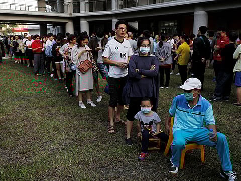 People queue to cast their votes at a polling station in Kaohsiung, Taiwan, November 24, 2018.