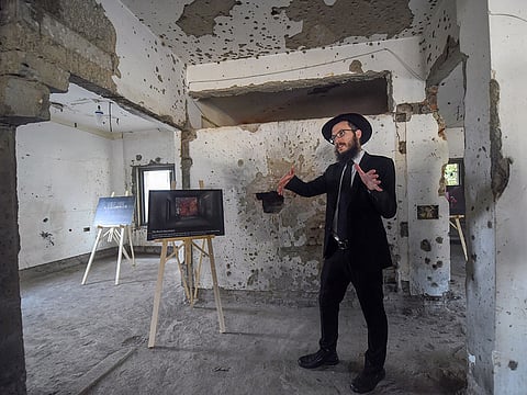 Chabad House Mumbai Director Rabbi Israel Kozlovsky gestures at bullet marks from 26/11 during a media visit on the eve of the tenth anniversary of the incident, in Mumbai, Sunday, Nov. 25, 2018.