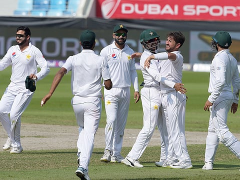 Pakistani spinner Yasir Shah (2R) celebrates with teammates after taking a wicket during the third day of the second Test cricket match against New Zealand at the Dubai International Cricket Stadium in Dubai on November 26, 2018.