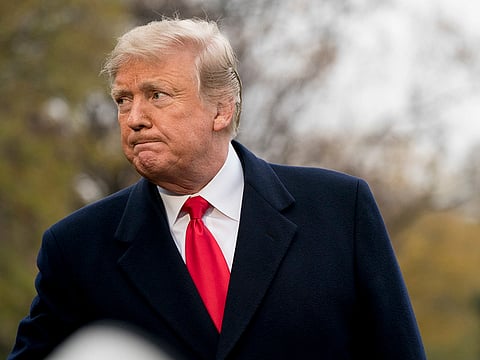 US President Donald Trump listens to a questions as he speaks to members of the media before boarding Marine One on the South Lawn of the White House in Washington.