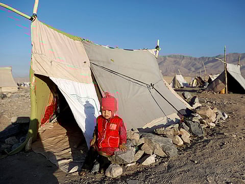 An internally displaced Afghan child sits outside a tent at a refugee camp in Herat province, Afghanistan October 14, 2018.