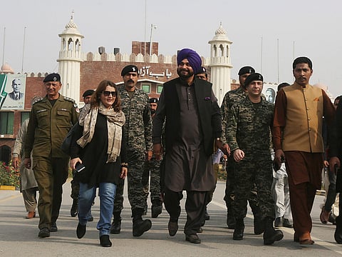 Former Indian cricketer-turned-politician Navjot Singh Sidhu, center, arrives at the Pakistani border post Wagha near Lahore, Pakistan, Tuesday, Nov. 27, 2018. Sidhu led his country's delegation to Pakistan for the groundbreaking ceremony of Kartarpur corridor on Wednesday, to give access to Indian Sikh pilgrims to visit the shrine of their spiritual leader Guru Nanak Dev in Pakistan.