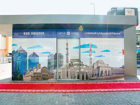 The bus shelters are equipped with electronic bulletin board displays showing bus service timetables and routes.