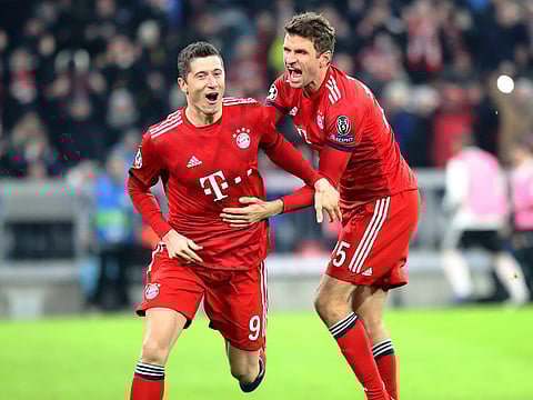 Bayern forward Robert Lewandowski, left, celebrates with Thomas Mueller.