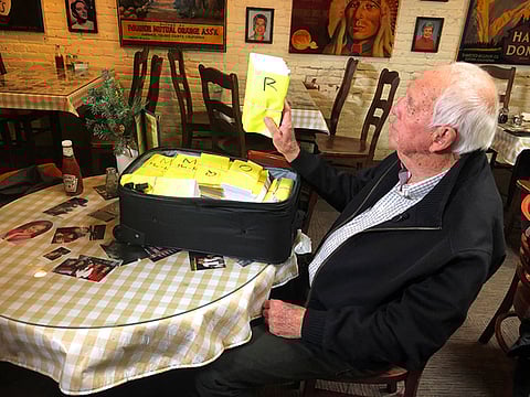 Bob Wilson, a San Diego restaurant owner and real estate developer pained over the destruction to the town of Paradise caused by the deadly Northern California Camp wildfire, holds some of $1.1 million to hand out to students and staff members - $1,000 each - from Paradise High School, at an assembly in Chico, California.