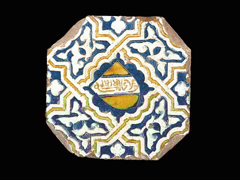 Alhambra tile, late 14th century, Malaga or Granada, Spain. Earthenware, painted over and incised in an opaque white glaze