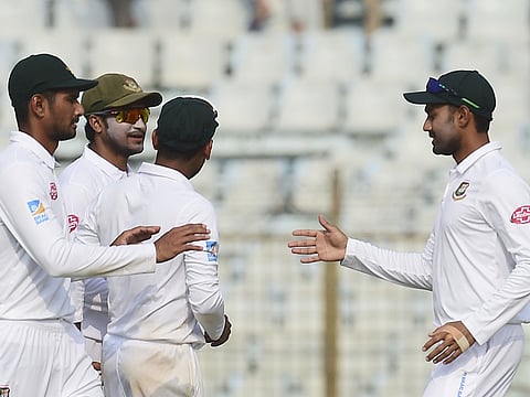 File photo: Bangladesh cricketer Mehidy Hasan (R) celebrates with teammates Shakib Al Hasan (2R) and Mohammad Mahmudullah (L) their win at the end of the third day of the first Test cricket on match between Bangladesh and West Indies at the Zahur Ahmed Chowdhury Stadium in Chittagong on November 24, 2018.