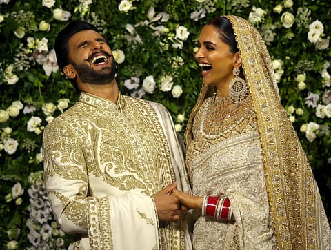 Bollywood actors Ranveer Singh and Deepika Padukone share a moment during a photo-op at their wedding reception in Mumbai, India, November 28, 2018.