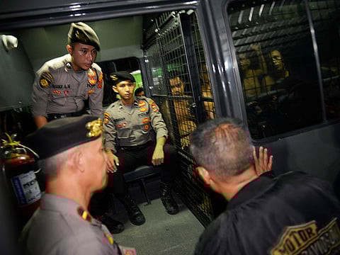 Police officers escort arrested inmates who escaped a prison in Banda Aceh, Aceh province, during a jailbreak on November 29, 2018.